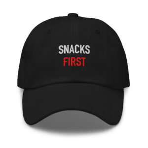 Black embroidered dad hat reading “SNACKS FIRST.” in white and red.