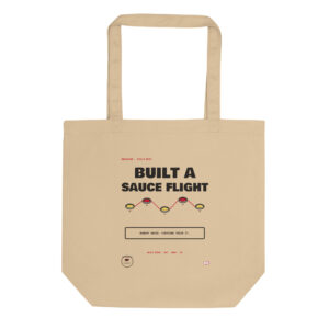 Front product mockup of the Aquarius Sauce Flight organic cotton tote.